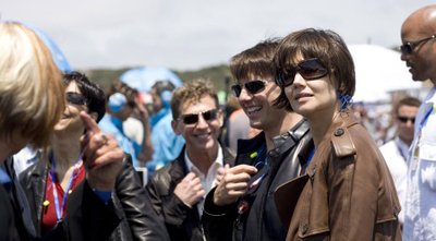 David Miscavige (center) parties with buddy Tom Cruise at a motorcycle race.